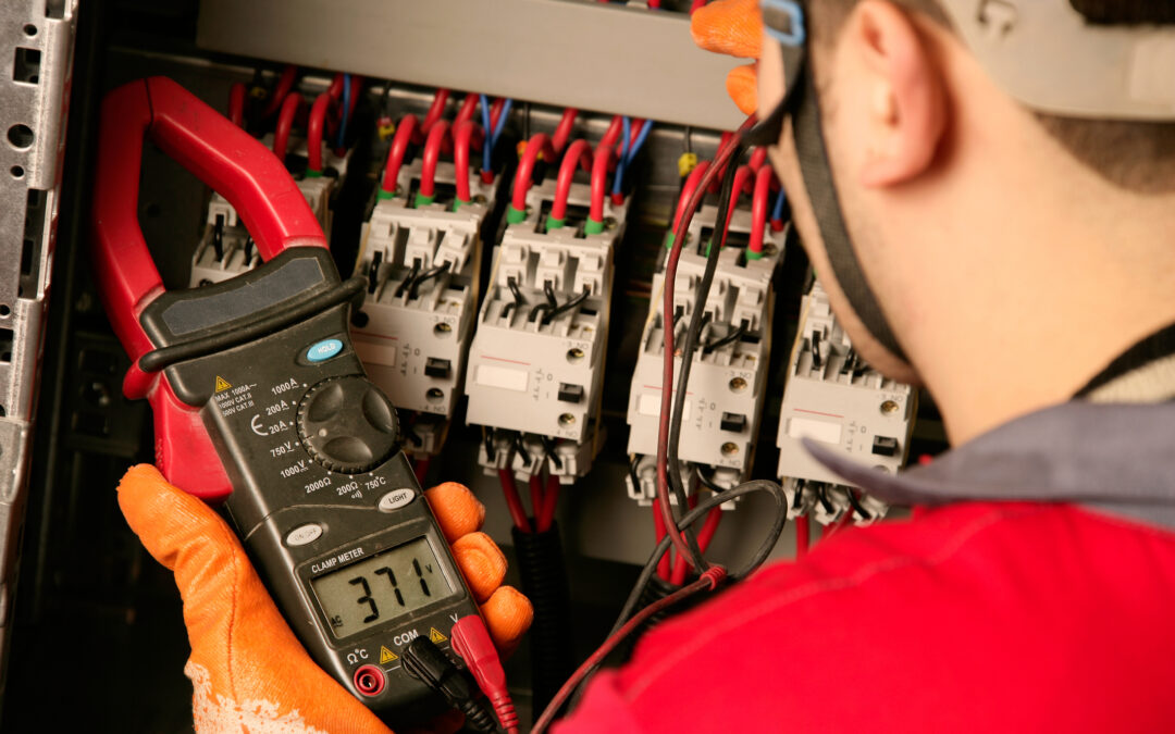 Electrician using a clamp meter to measure electrical current near circuit breakers in a residential electrical panel, emphasizing safety and efficiency in home electrical systems.