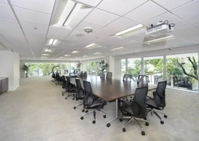 Modern conference room with large table, ergonomic chairs, and natural light, ideal for Kazar’s Electric project discussions.