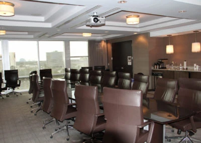 Conference room at Kazar’s Electric, Inc. with modern furniture and city view, ideal for meetings and presentations.