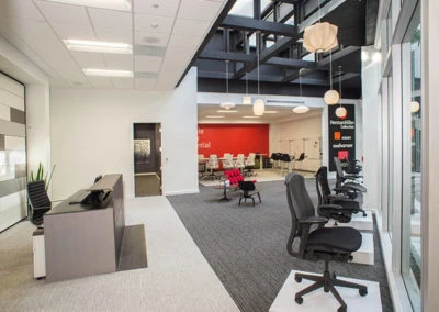 Modern office reception area with Kazar’s Electric branding, featuring a minimalist design and natural light.
