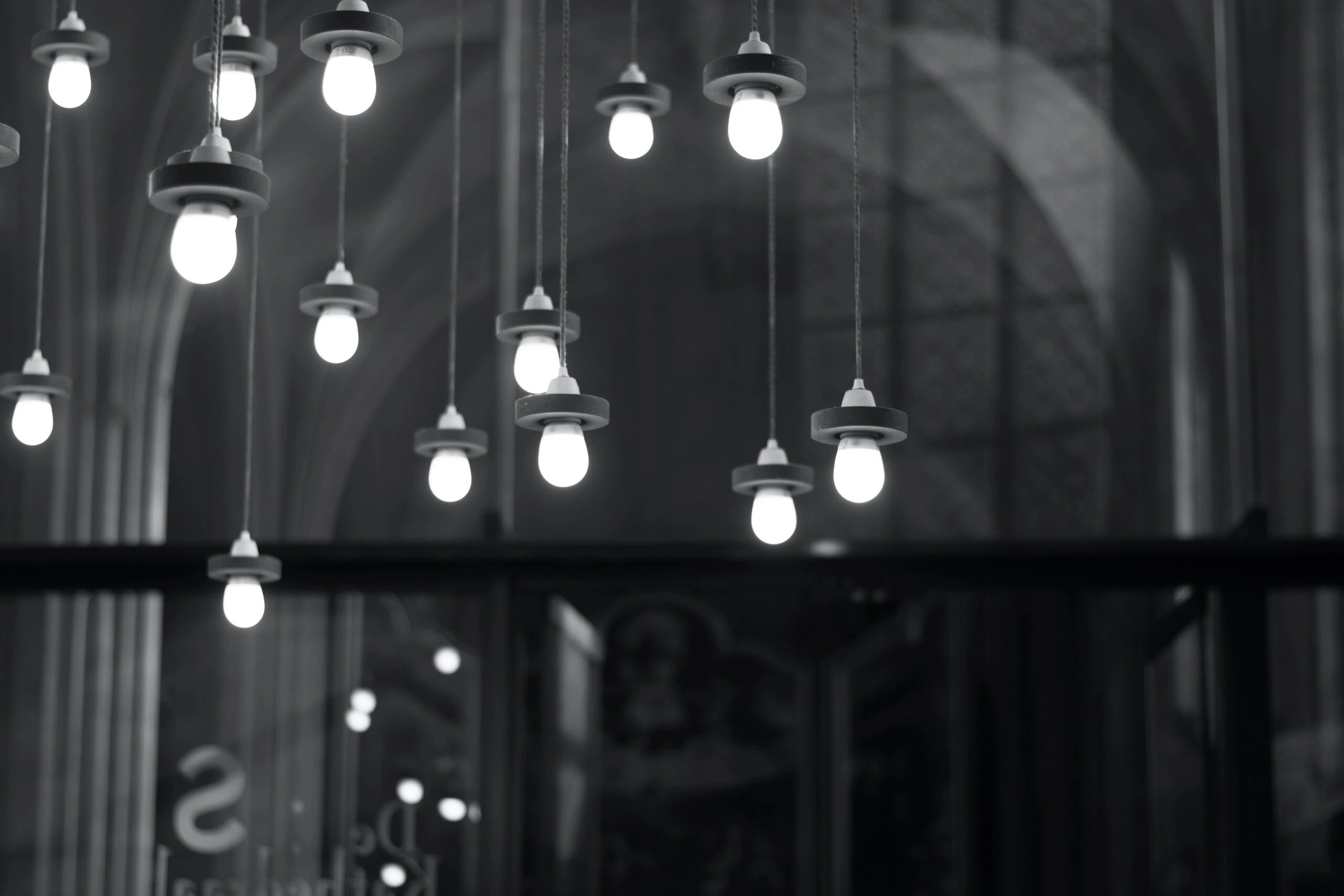 Modern hanging light bulbs illuminating a minimalistic space, showcasing energy-efficient upgrades by Kazar's Electric.